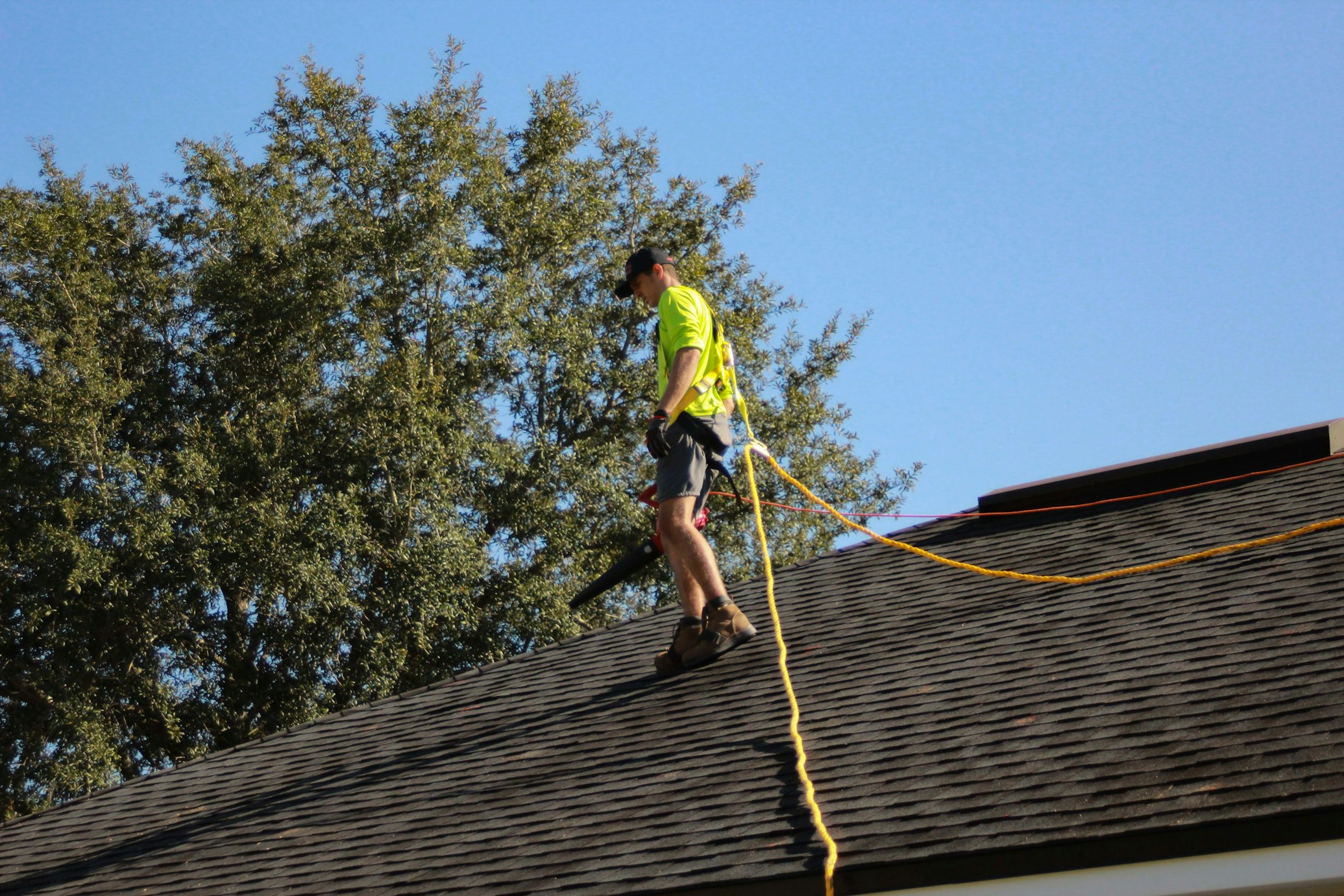 Roofing professional repairing damaged shingles on a residential roof